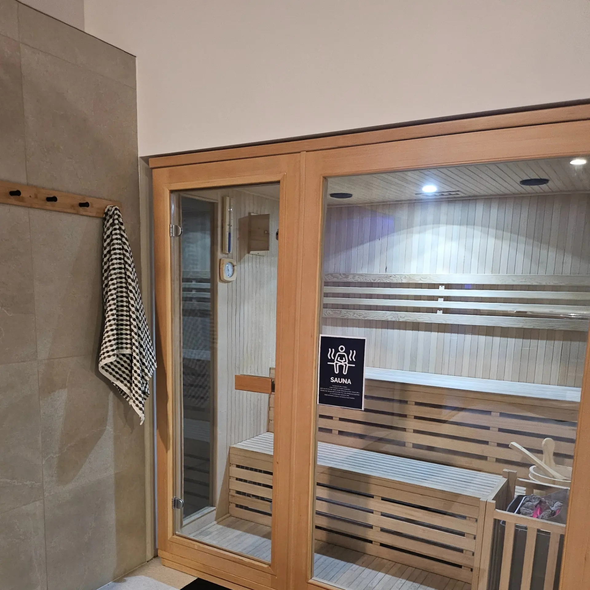Traditional cedar sauna room with tiered benches at Recovery Hub Lower Hutt